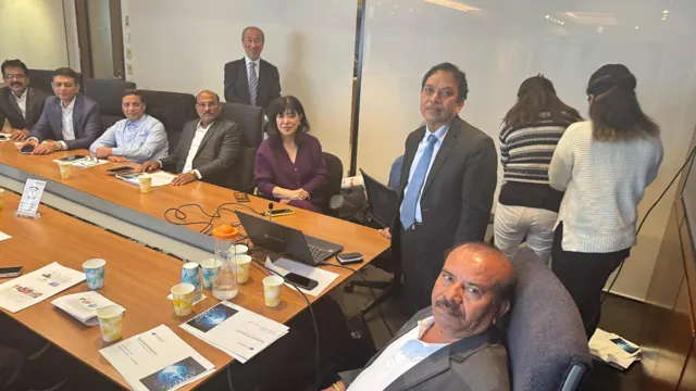 Business representatives exchanging ideas around a meeting table